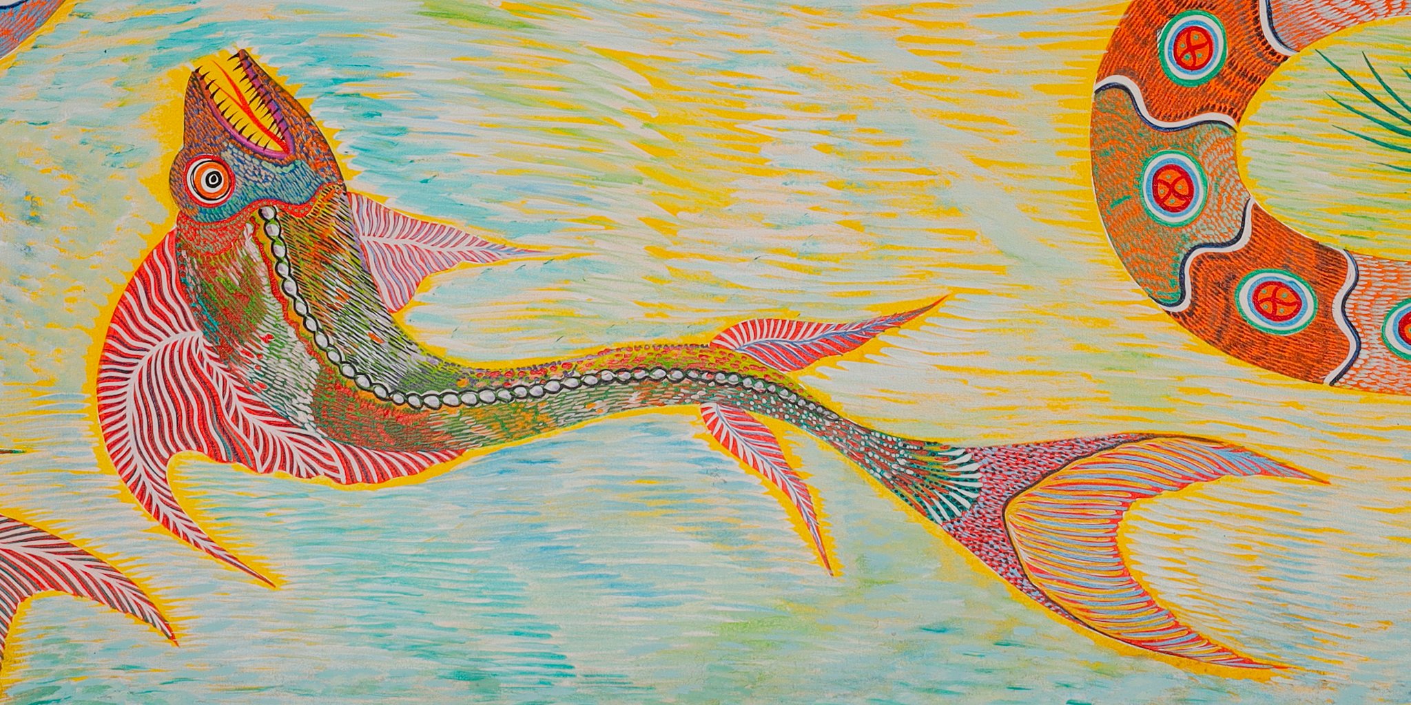 Long fish with a raised head and its tail stretched out to the right, at the bottom center. Detail of Fish Birds and Snake, Chico da Silva by Babá, 2006.